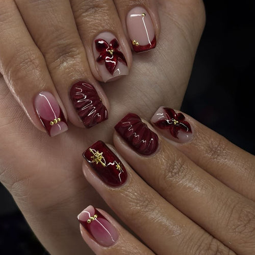 Artful nail design with floral and golden accents Bowlift