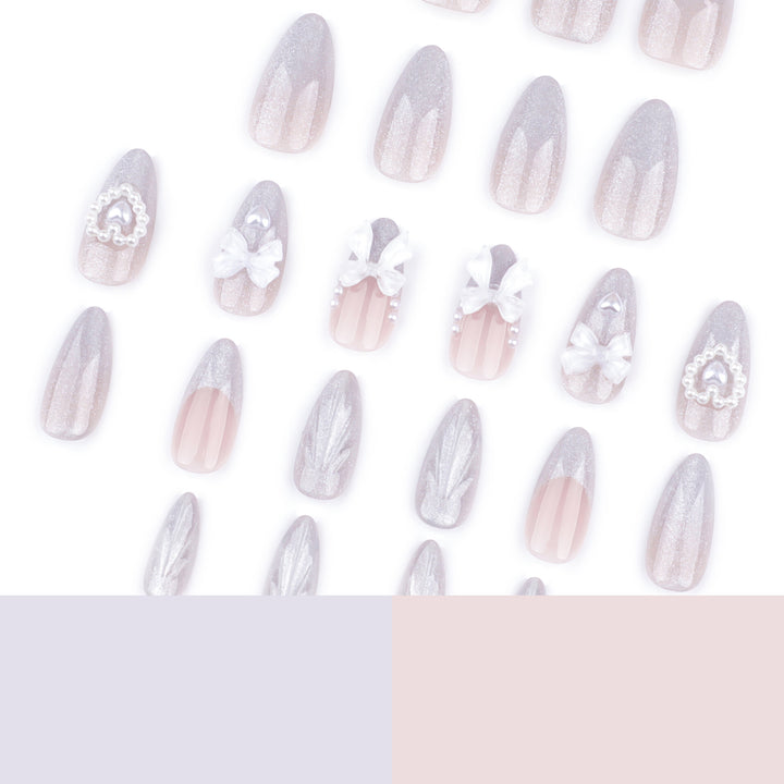 Artful nail decoration with pearl and bow accents Bowlift