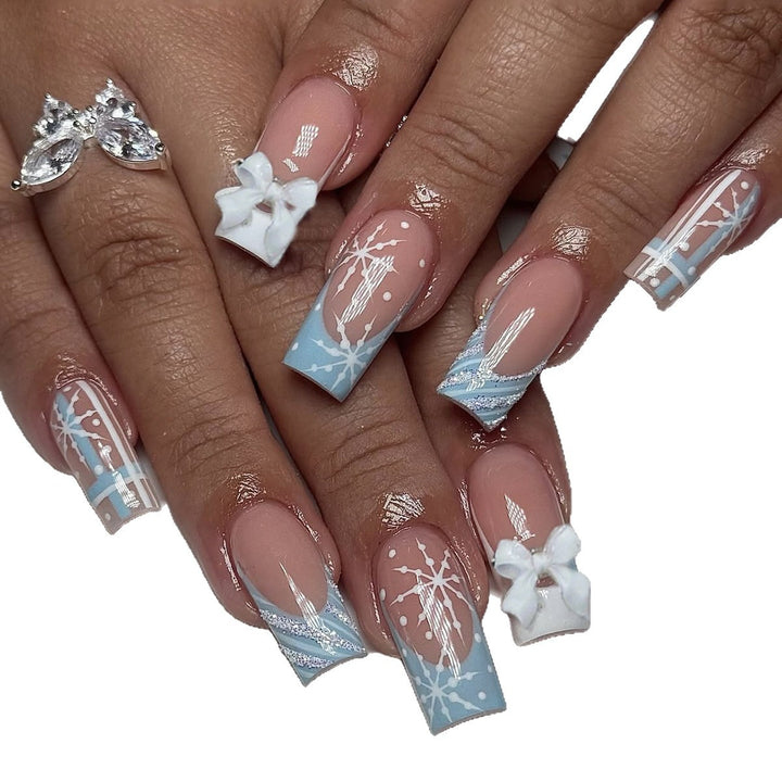 Artificial nail set with winter snowflake and bow motifs Bowlift
