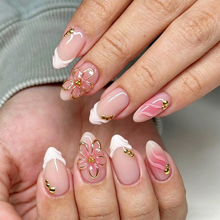 Artificial nail set with glamorous floral designs and creative glitter accents Bowlift