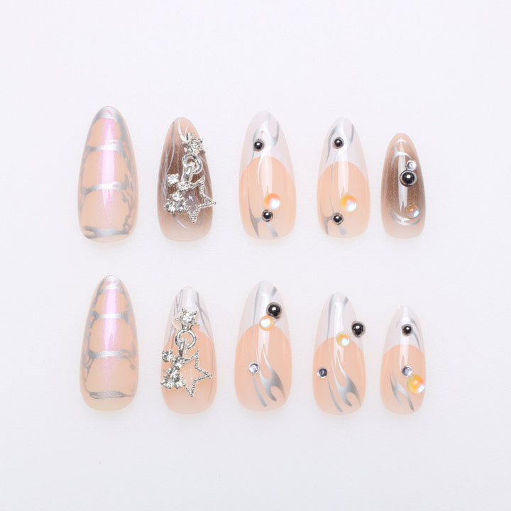 Artistic Stiletto Nail Extensions with Metallic Accents Bowlift