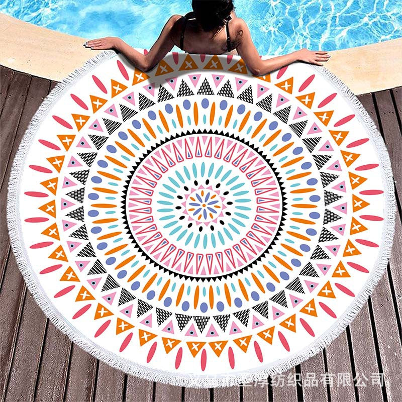 Round beach towel with colorful, tropical floral pattern and fringe decoration Bowlift