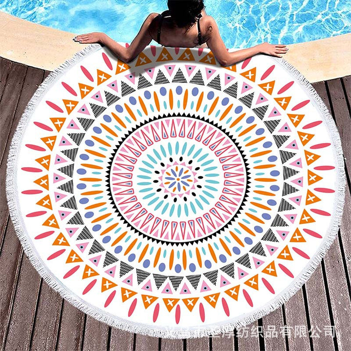 Round beach towel with colorful, tropical floral pattern and fringe decoration Bowlift