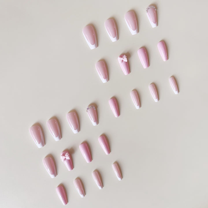 Artificial nail set with playful bows and glitter accents Bowlift