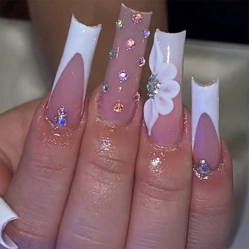 Artful stiletto nails with floral accents and rhinestone details Bowlift