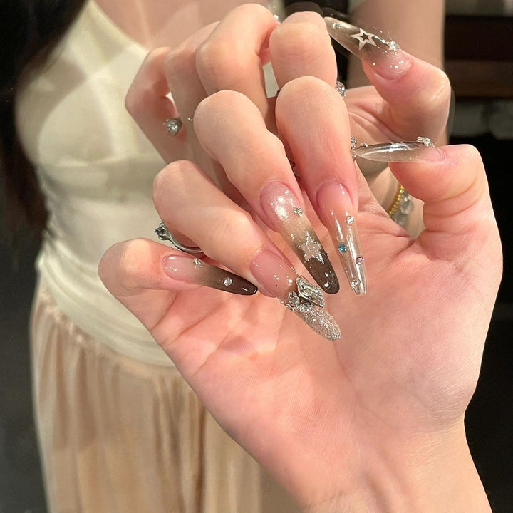Glamorous artificial nails with sparkling rhinestone and star designs Bowlift