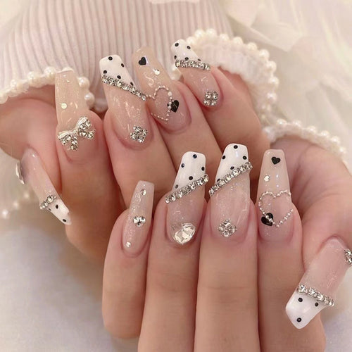 Artful nail extensions with elegant rhinestone and heart designs Bowlift