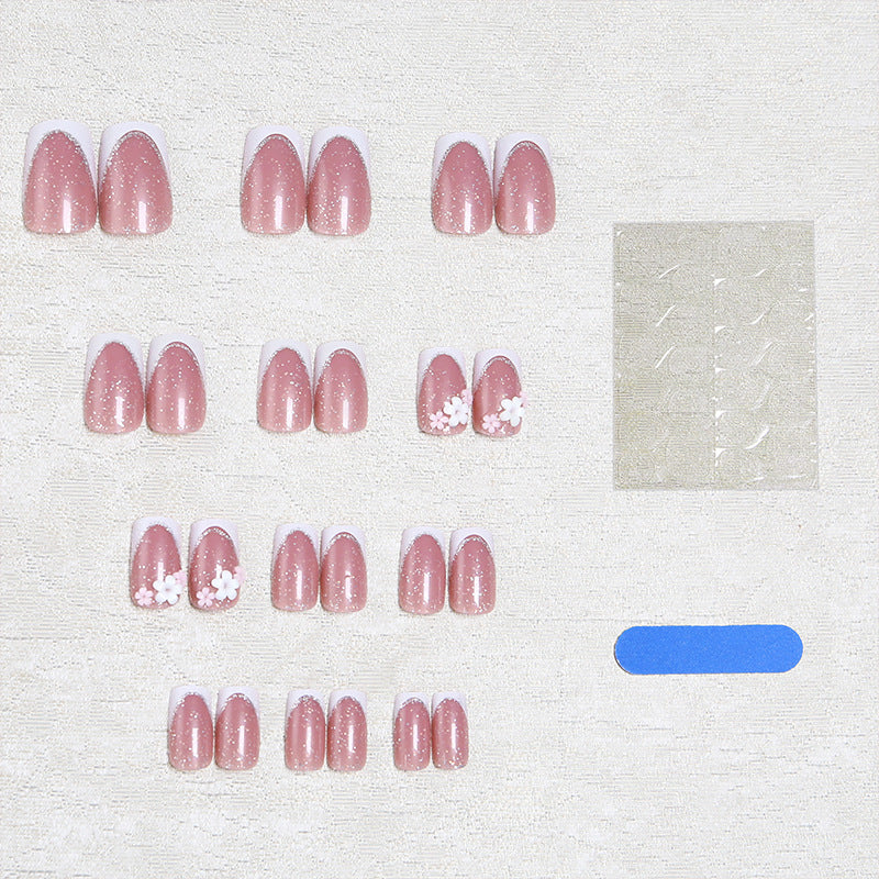 Acrylic nail set with elegant French tip and delicate floral decorations Bowlift