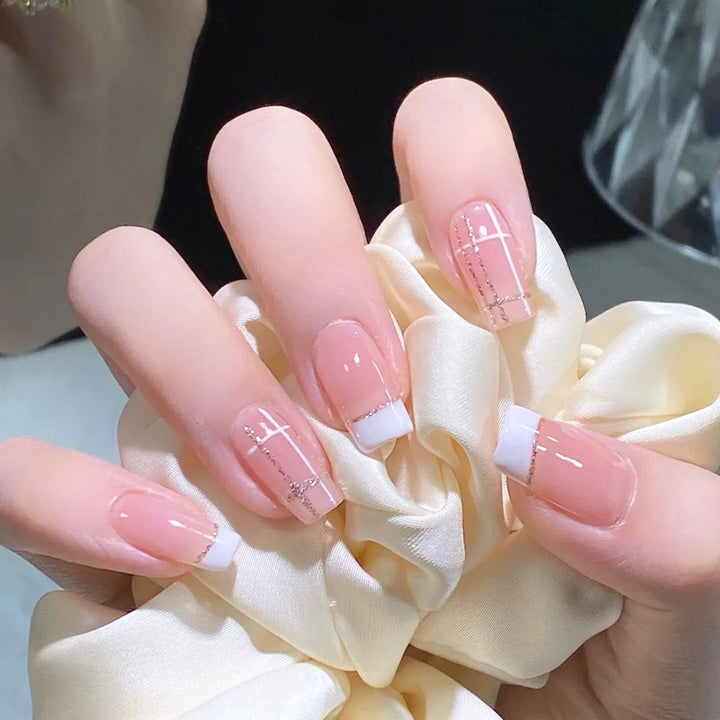 Nail set with elegant French tip and fashionable embellishments Bowlift
