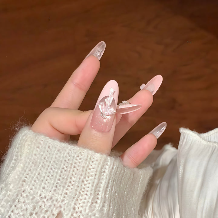 Artificial nail tips with glamorous glitter and bow details Bowlift