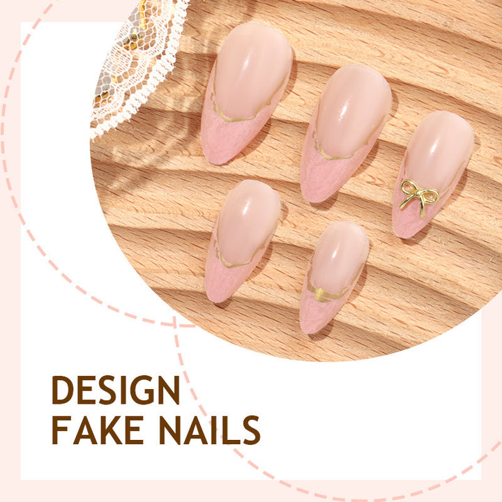 Artificial nail set with delicate bows and golden accents Bowlift