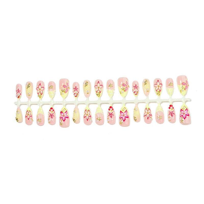 Artificial nail set with delicate floral decorations and glitter accents Bowlift
