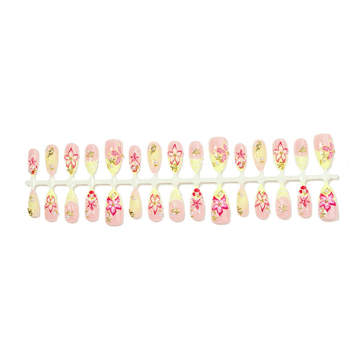 Artificial nail set with delicate floral decorations and glitter accents Bowlift