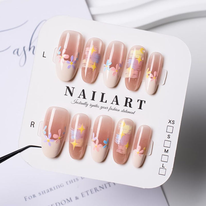 Artificial nails with delicate floral accents and glitter effects Bowlift