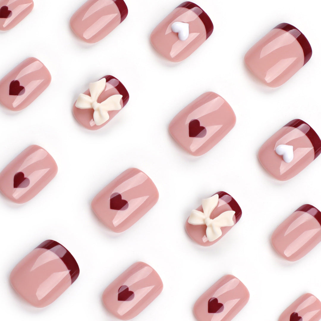 Artful nail art with heart and bow motifs Bowlift