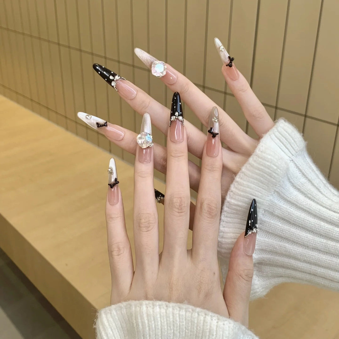 Elegantly designed artificial nails in luxurious design with decorative rhinestone applications Bowlift