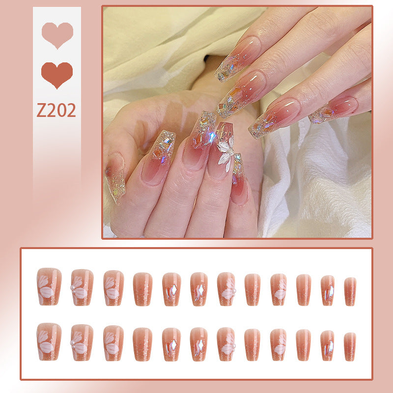 Artificial nail set with floral and glittering accents Bowlift
