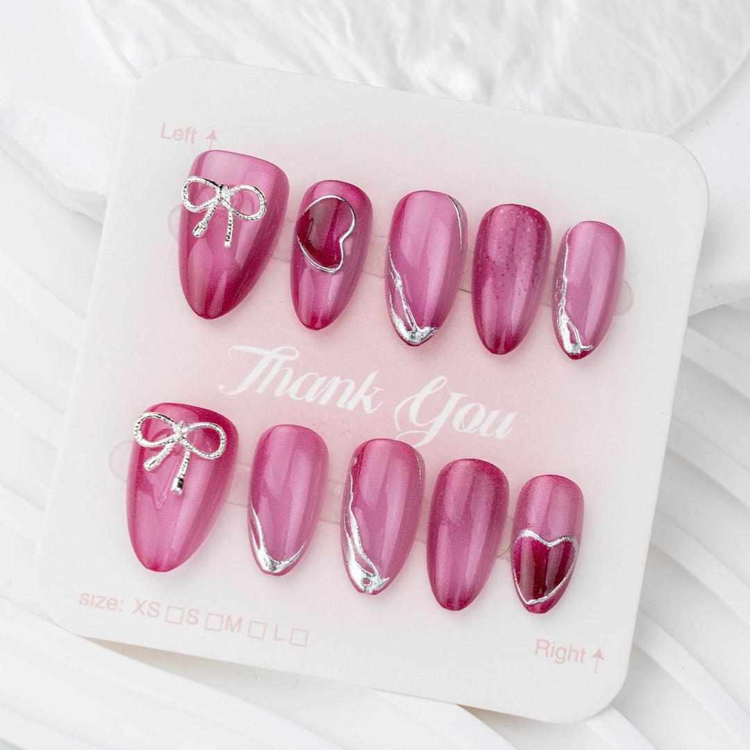 Acrylic nail set with elegant heart and bow decorations Bowlift