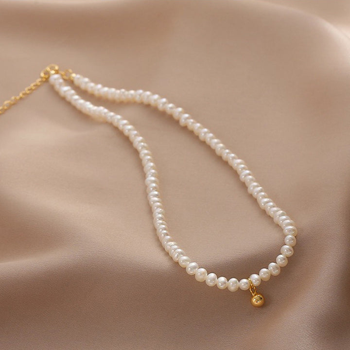 Delicate pearl necklace with elegant gold accent chain Bowlift