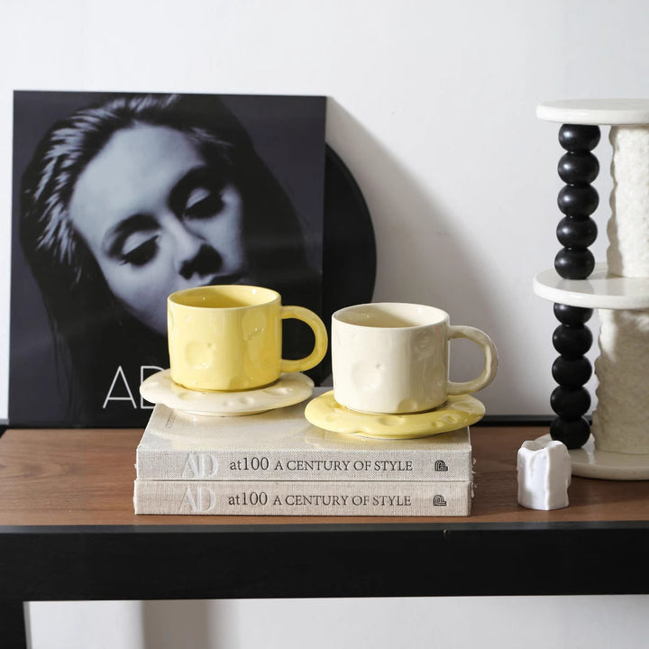 Ceramic coffee cup set with textured relief surface and wavy saucer