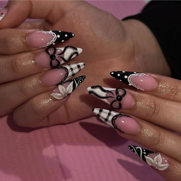 Artful stiletto nails with floral and geometric accents Bowlift