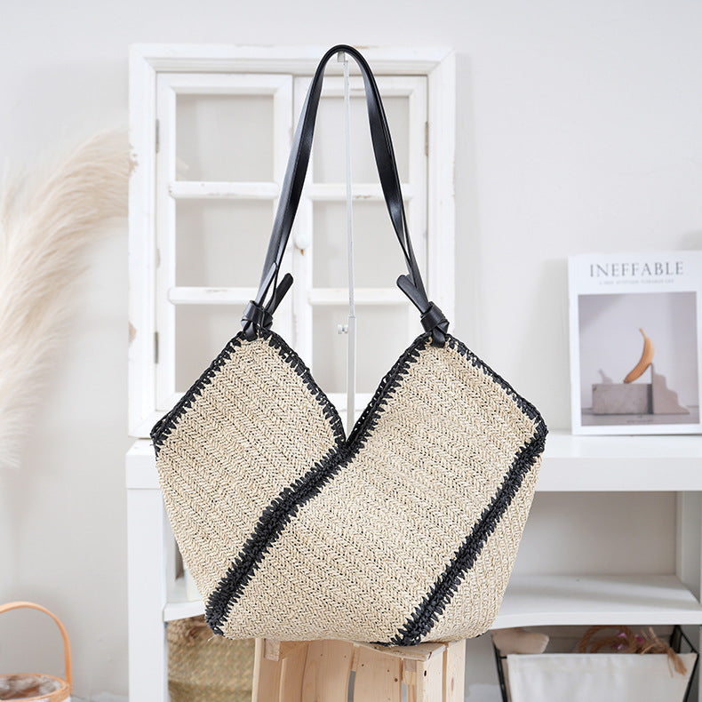 Handbag made of braided natural material with contrasting leather handles Bowlift