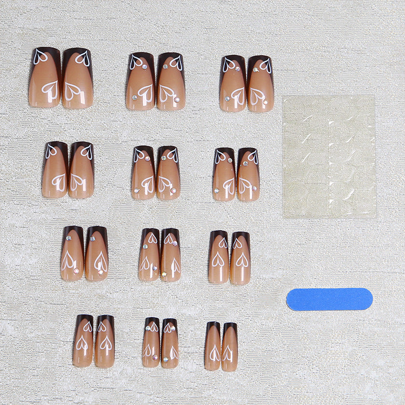 Elegant artificial nails with heart pattern and glitter accents Bowlift