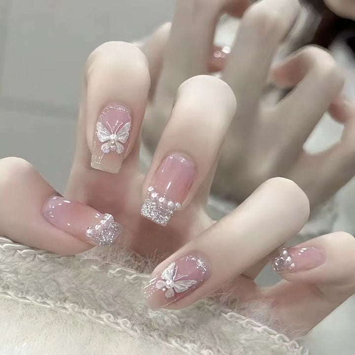 Artistic Nail Art with Glitter and Flower Applications Bowlift