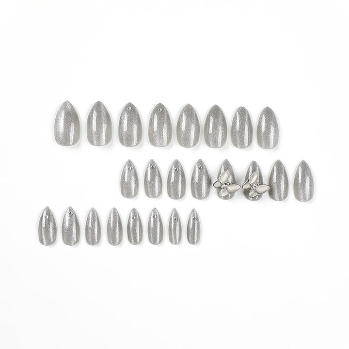 Glamorous stiletto nails with radiant glitter and elegant 3D design Bowlift