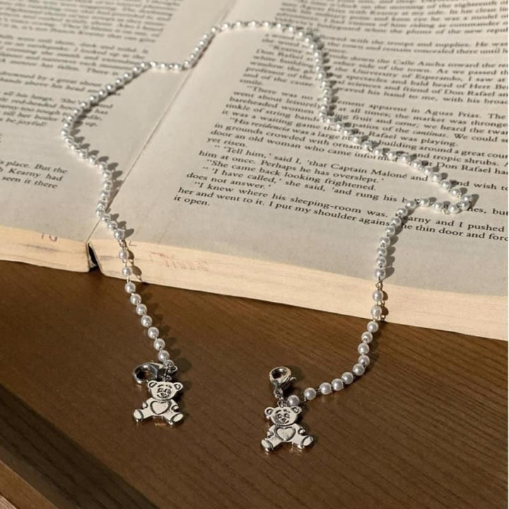 Playful pearl necklace with gold pendants Bowlift