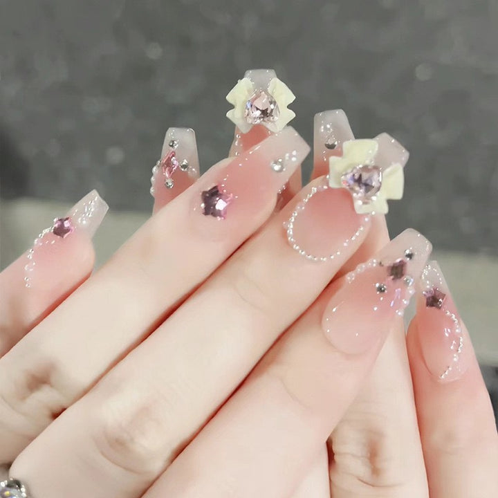 Glamorous artificial nails with moon and star motifs Bowlift