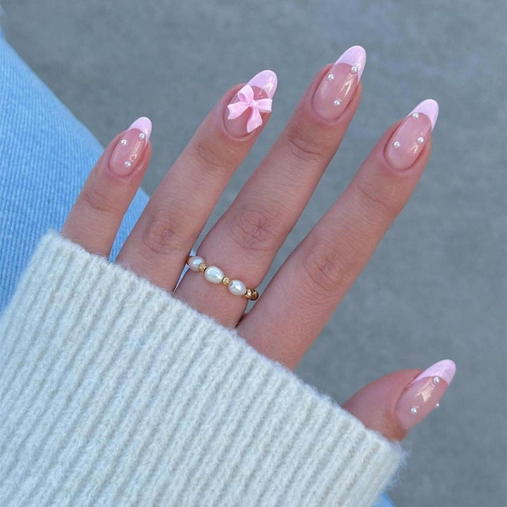 Artificial nail set with delicate bow and glitter accents Bowlift