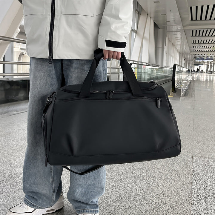 Sporty travel bag with reinforced carrying handles and multiple compartments Bowlift