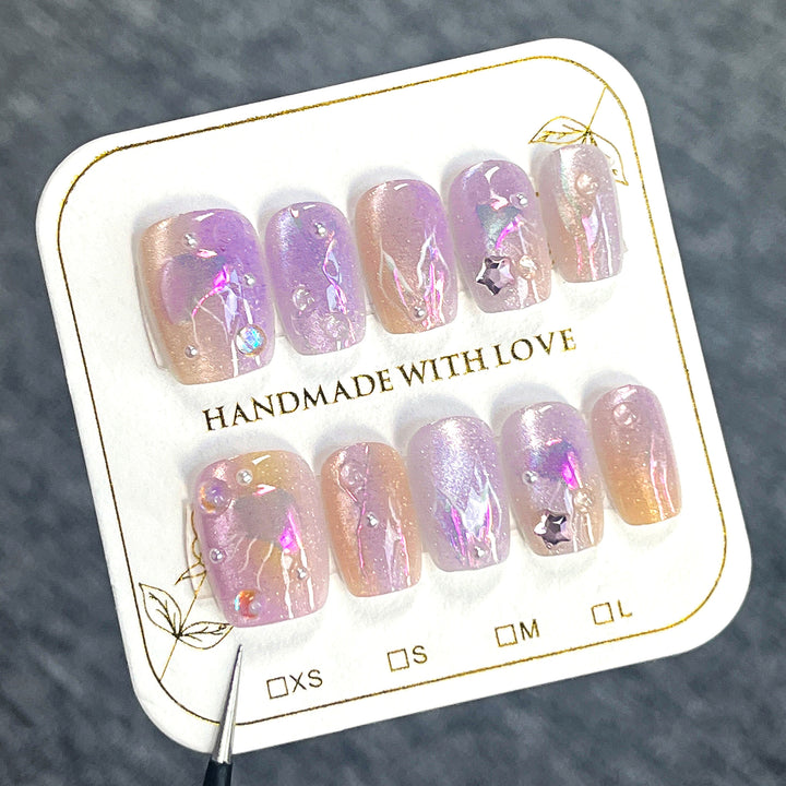 Artificial nail art with sparkling accents and transparent color gradient Bowlift