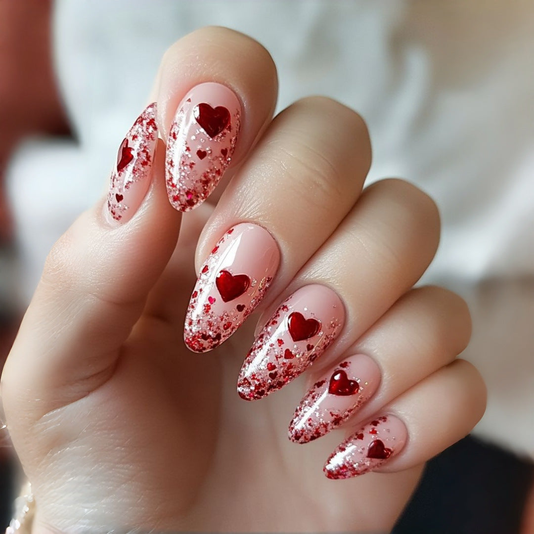 Glamorous artificial nails with heart design and glitter Bowlift