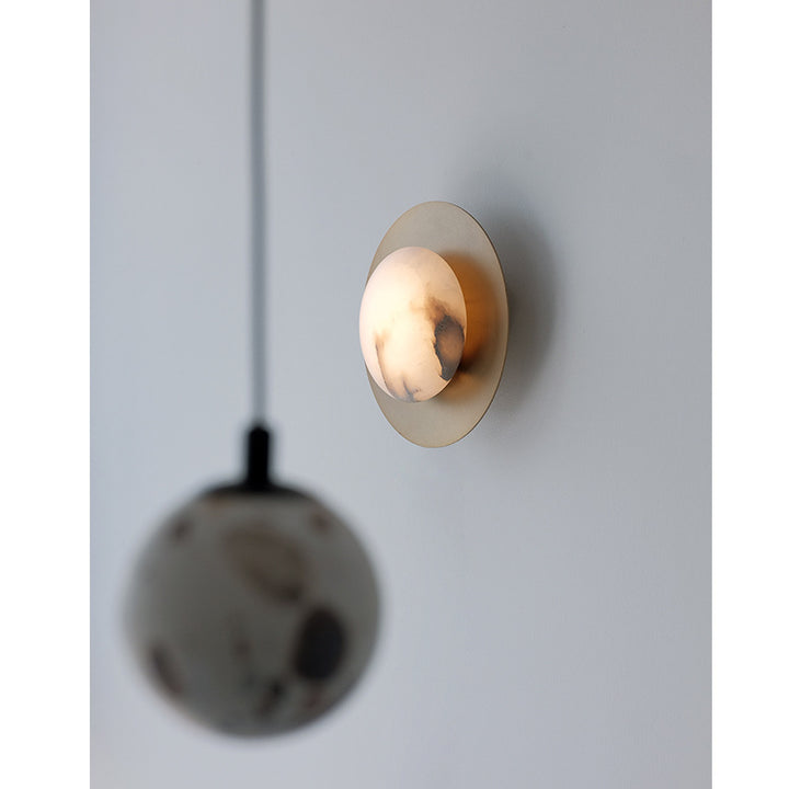 Contemporary alabaster globe wall sconce with round metal backplate Bowlift