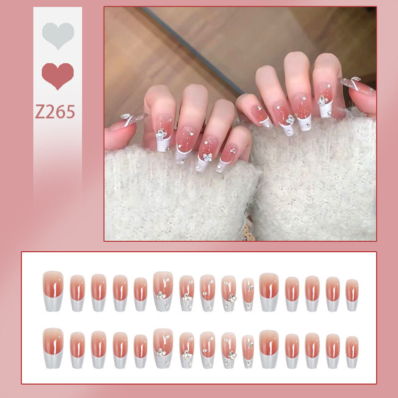 Nail art set with elegant wave patterns and delicate pearl accents Bowlift