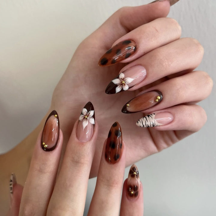 Artistic stiletto nails with elegant floral designs and glitter accents Bowlift
