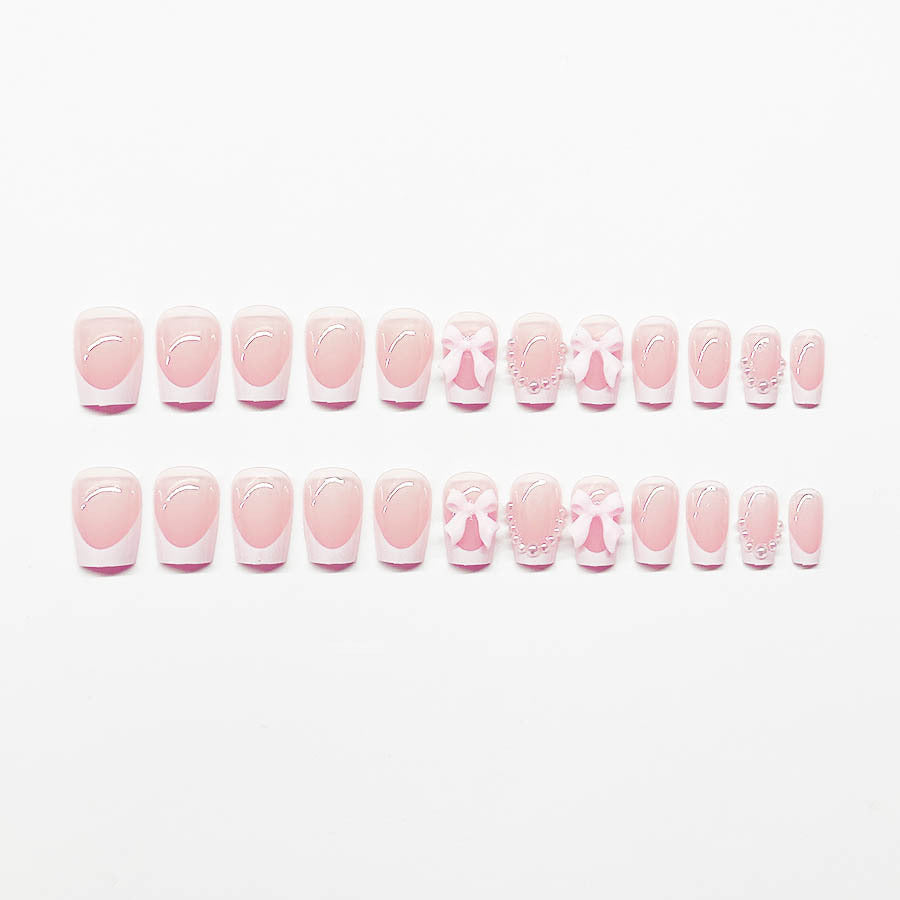 Artificial nails with elegant bows and pearl embellishments Bowlift