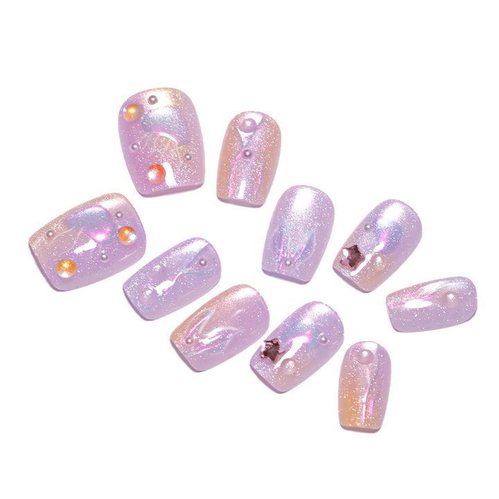 Artificial nail art with sparkling accents and transparent color gradient Bowlift