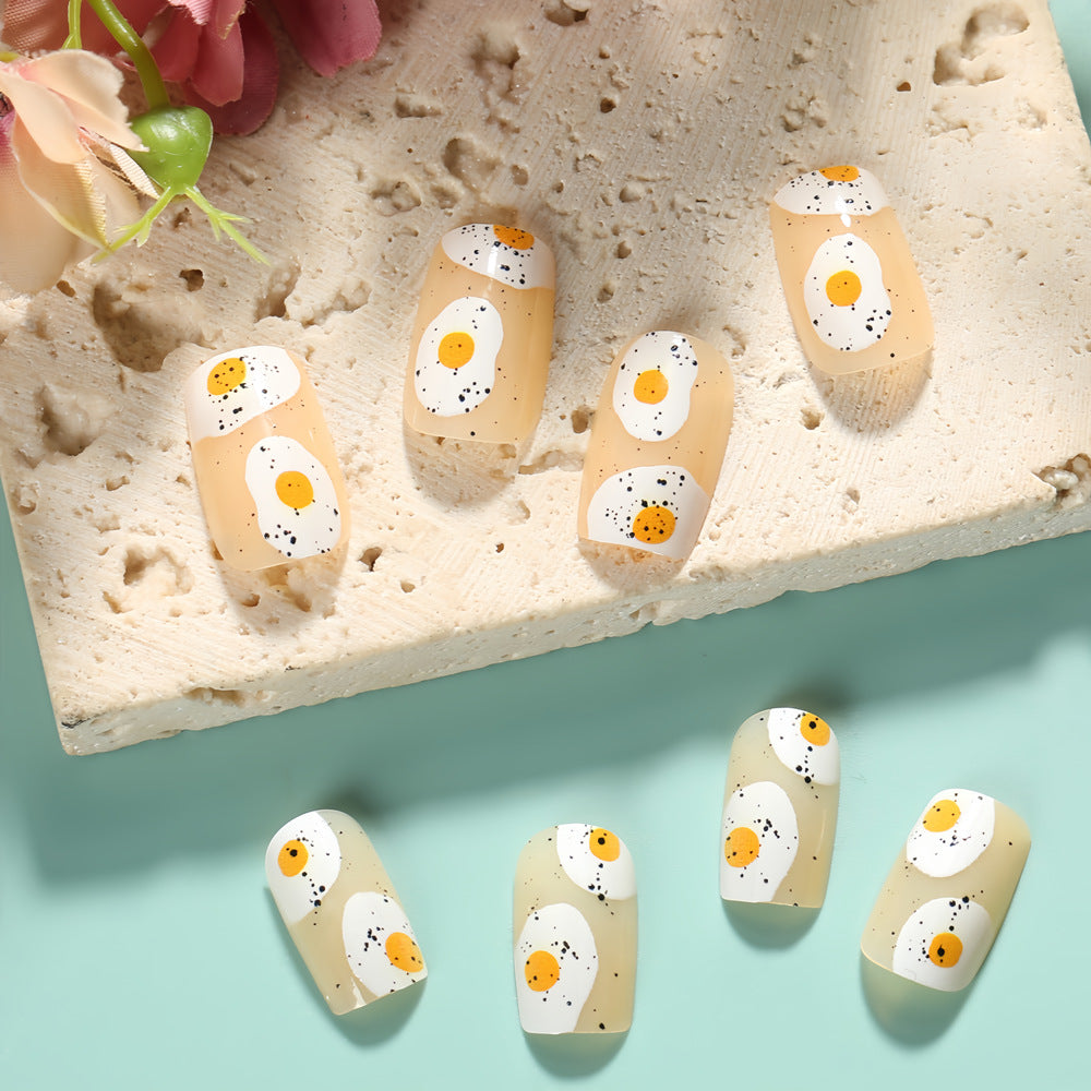 Artificial nails in creative fried egg design Bowlift