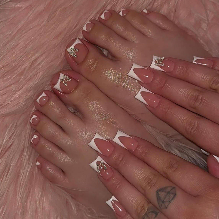 Artificial nail set with elegant French tip design and modern accents Bowlift