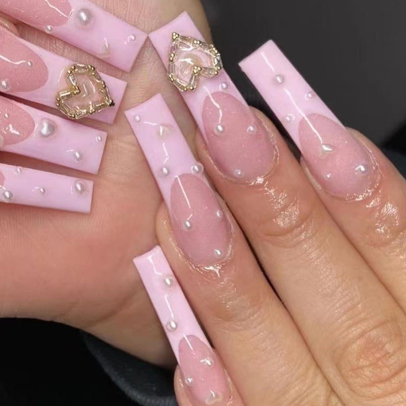 Artistic nail art with heart and pearl accents Bowlift