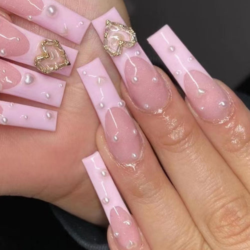 Artistic nail art with heart and pearl accents Bowlift