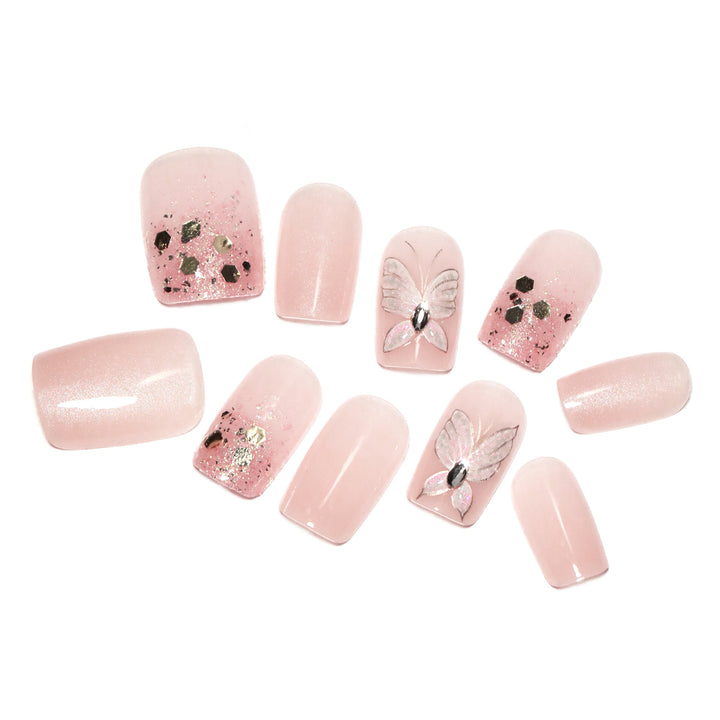 Artful nail art with butterfly designs and glitter accents Bowlift