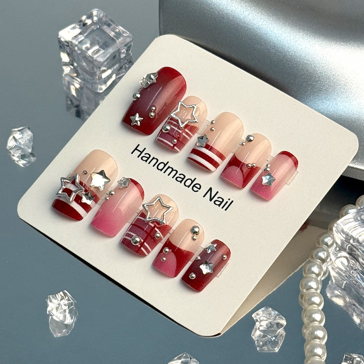 Artificial fingernails with handcrafted star decorations Bowlift