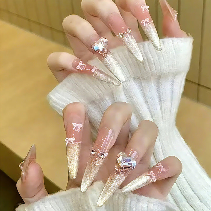 Art nail set with sparkling tips and delicate bow decorations Bowlift