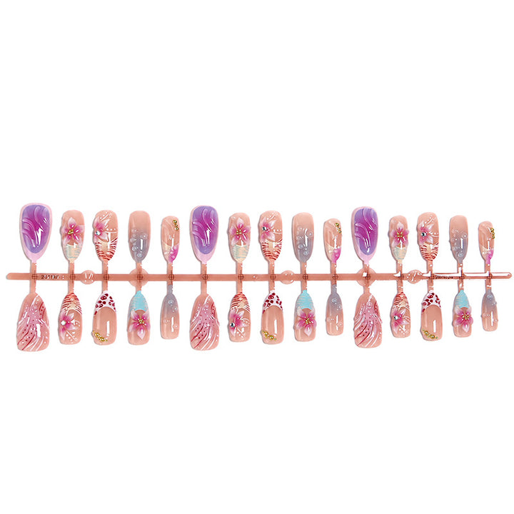 Artificial nail set with floral designs and glamorous accents Bowlift