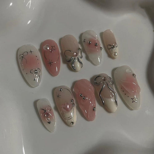 Artistic Nail Tips with Glitter and Bow Motifs Bowlift