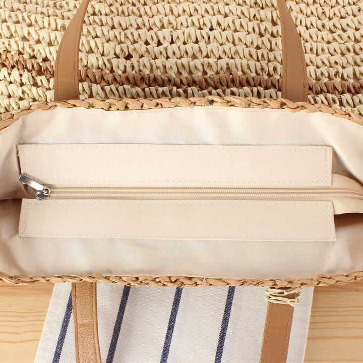 Handbag made of braided natural material with decorative tassel pendant Bowlift